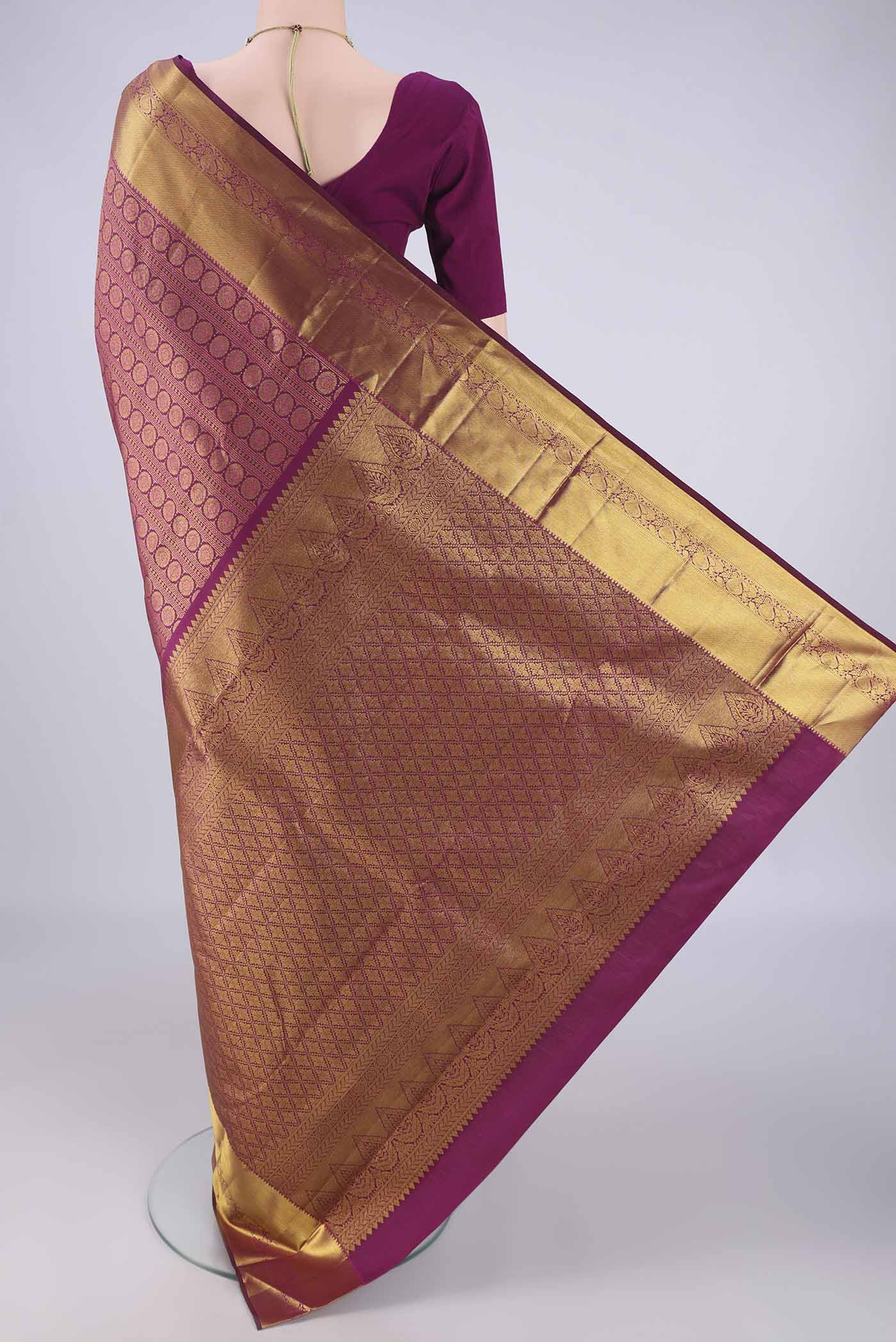 Flat view of Burgundy Kanjivaram Silk Saree with Zari Brocade on the body and Zari Border. 