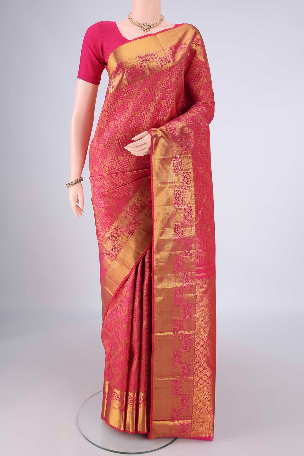 Rani Pink Kanjivaram Silk Saree with Zari Brocade on the body and Zari Border.  displayed on a mannequin