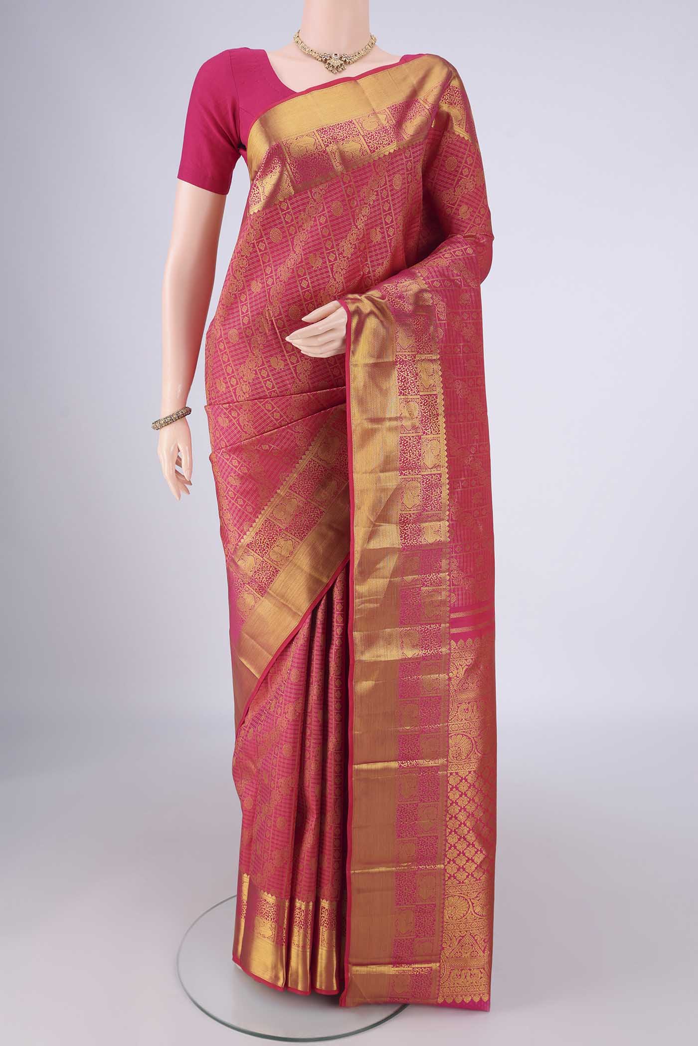 Rani Pink Kanjivaram Silk Saree with Zari Brocade on the body and Zari Border.  displayed on a mannequin