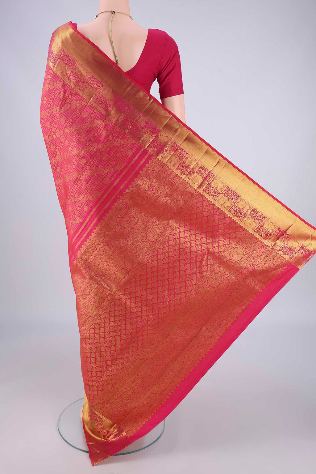 Flat view of Rani Pink Kanjivaram Silk Saree with Zari Brocade on the body and Zari Border. 