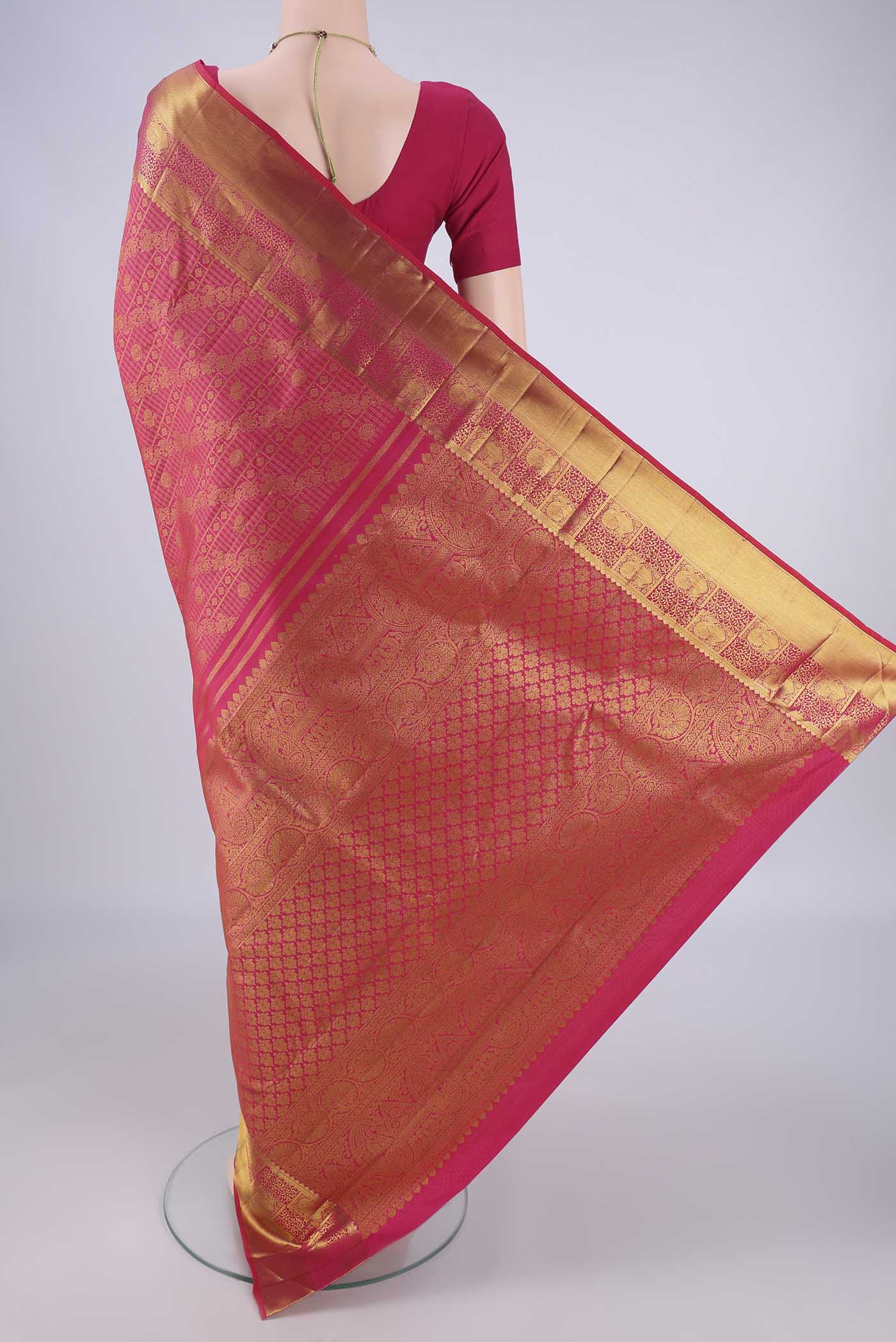 Flat view of Rani Pink Kanjivaram Silk Saree with Zari Brocade on the body and Zari Border. 