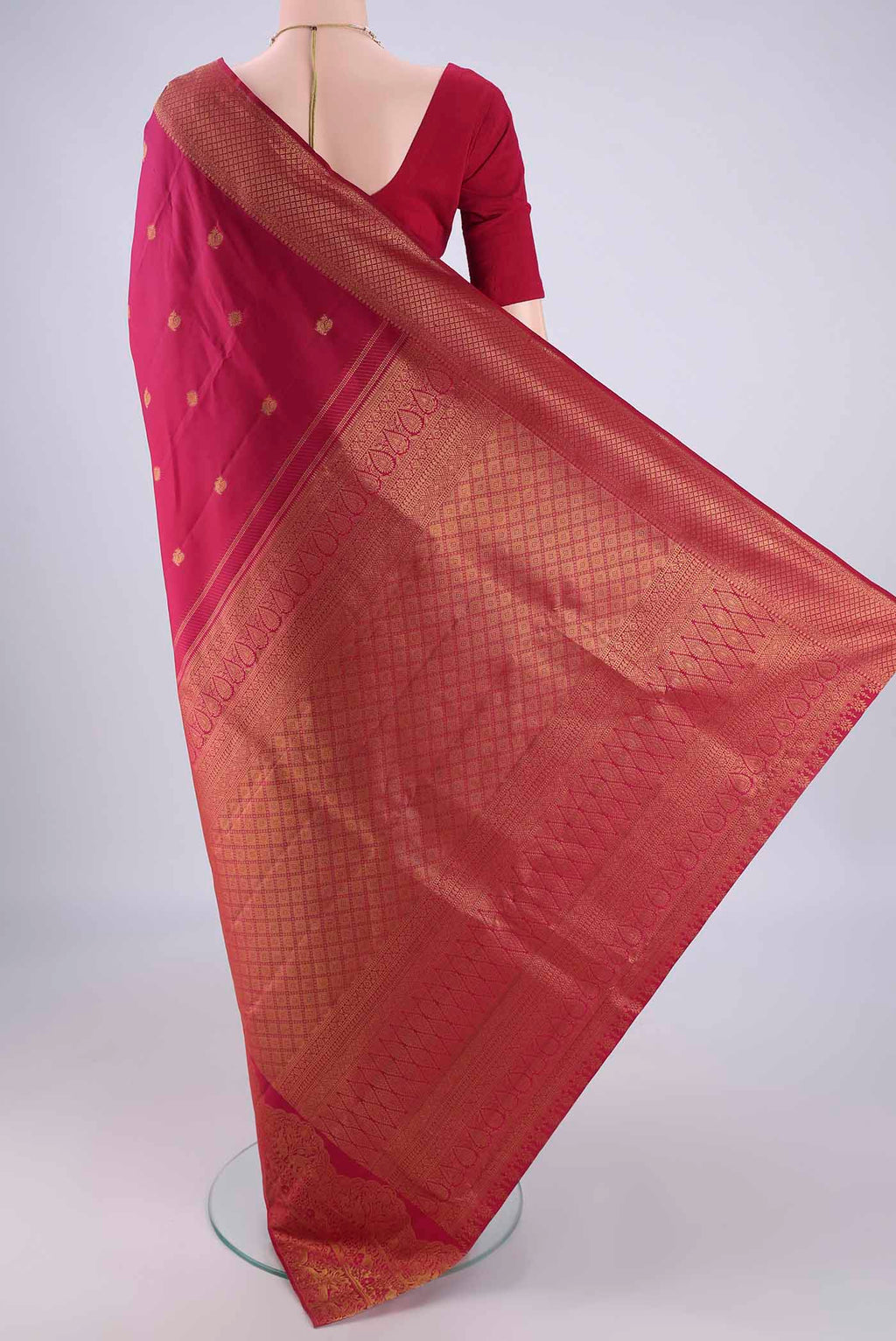 Flat view of Maroon Kanchipuram Silk Saree with Zari Butta on the body and Zari Border. 