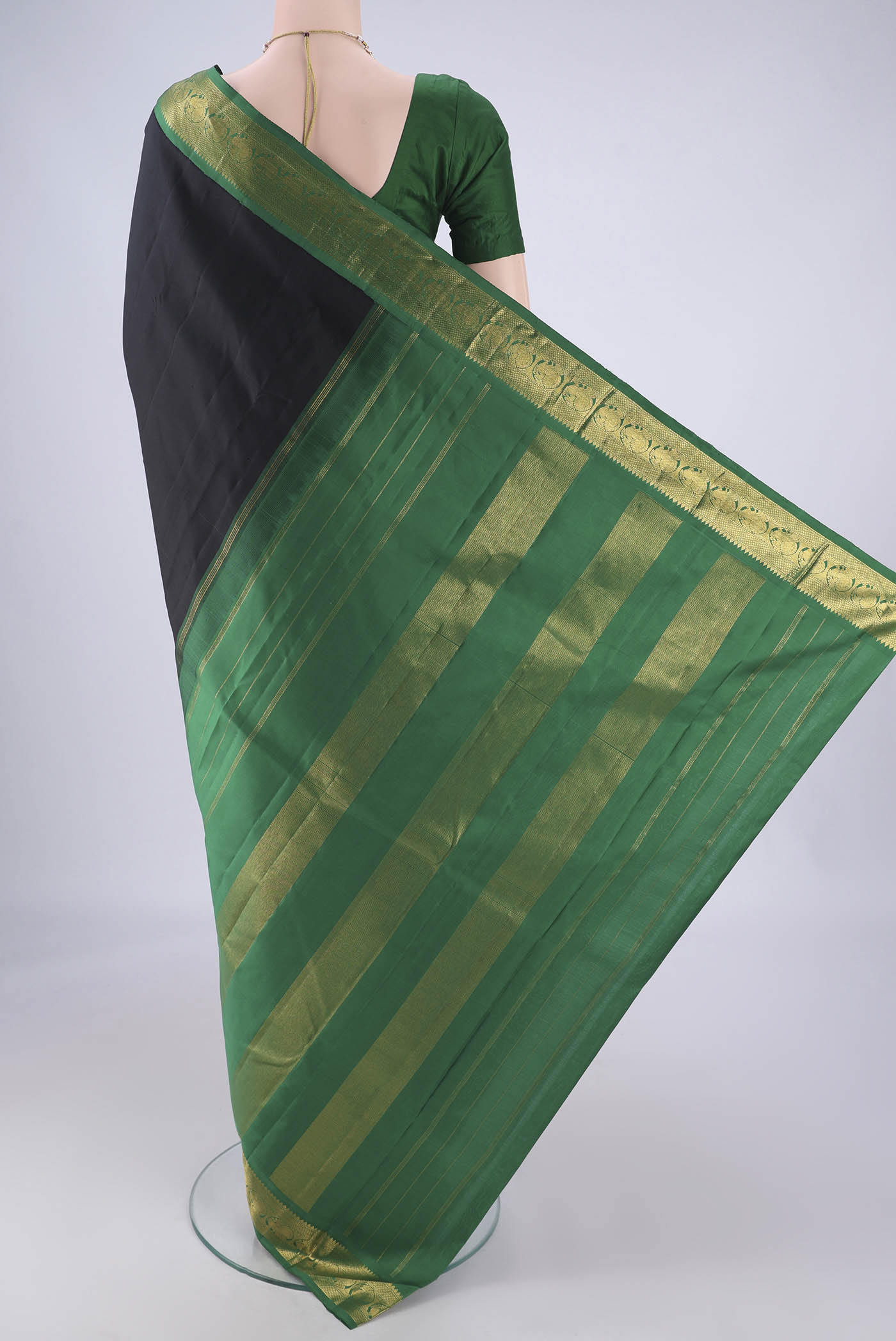 Flat view of Black Dual Tone Kanjivaram Silk Saree with Plain Body and Zari Border. 