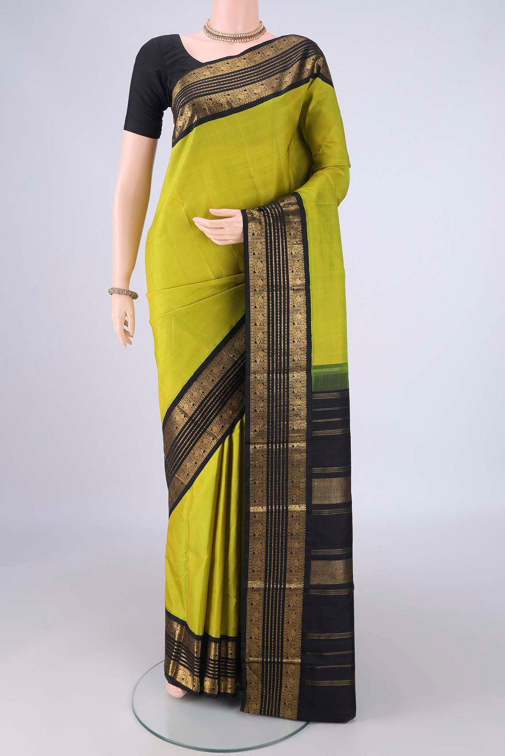 Parrot Green Dual Tone Kanjivaram Silk Saree with Plain Body and Zari Border.  displayed on a mannequin