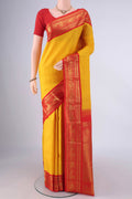 Pure Silk Yellow Kanjivaram Saree with Plain Body and Zari Border.  displayed on a mannequin