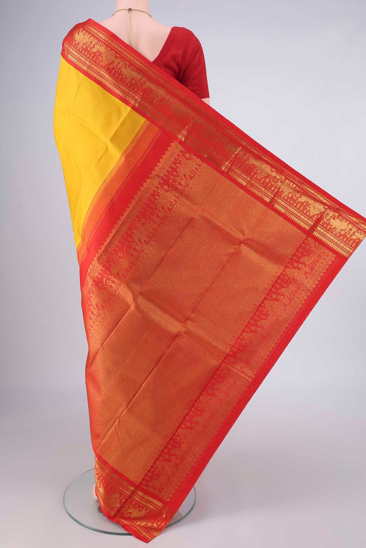 Flat view of Pure Silk Yellow Kanjivaram Saree with Plain Body and Zari Border. 