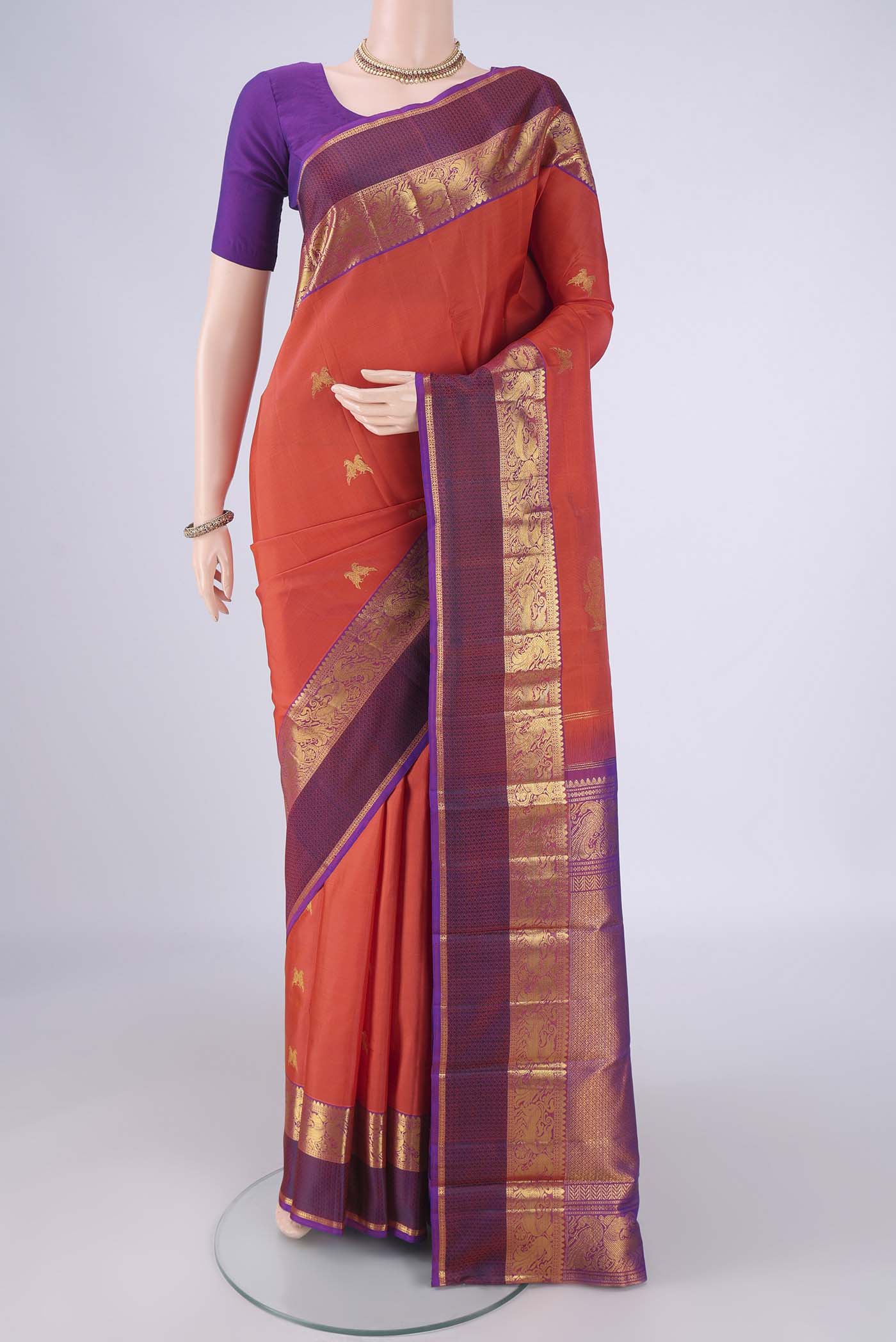 Rust Dual Tone Kanjivaram Silk Saree with Zari Butta on the body and Zari Border.  displayed on a mannequin
