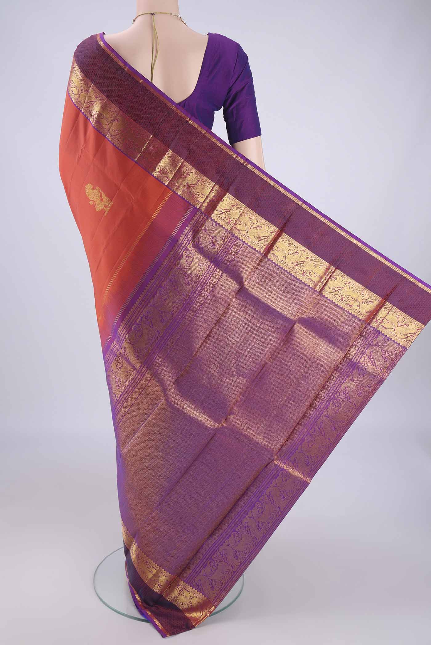 Flat view of Rust Dual Tone Kanjivaram Silk Saree with Zari Butta on the body and Zari Border. 