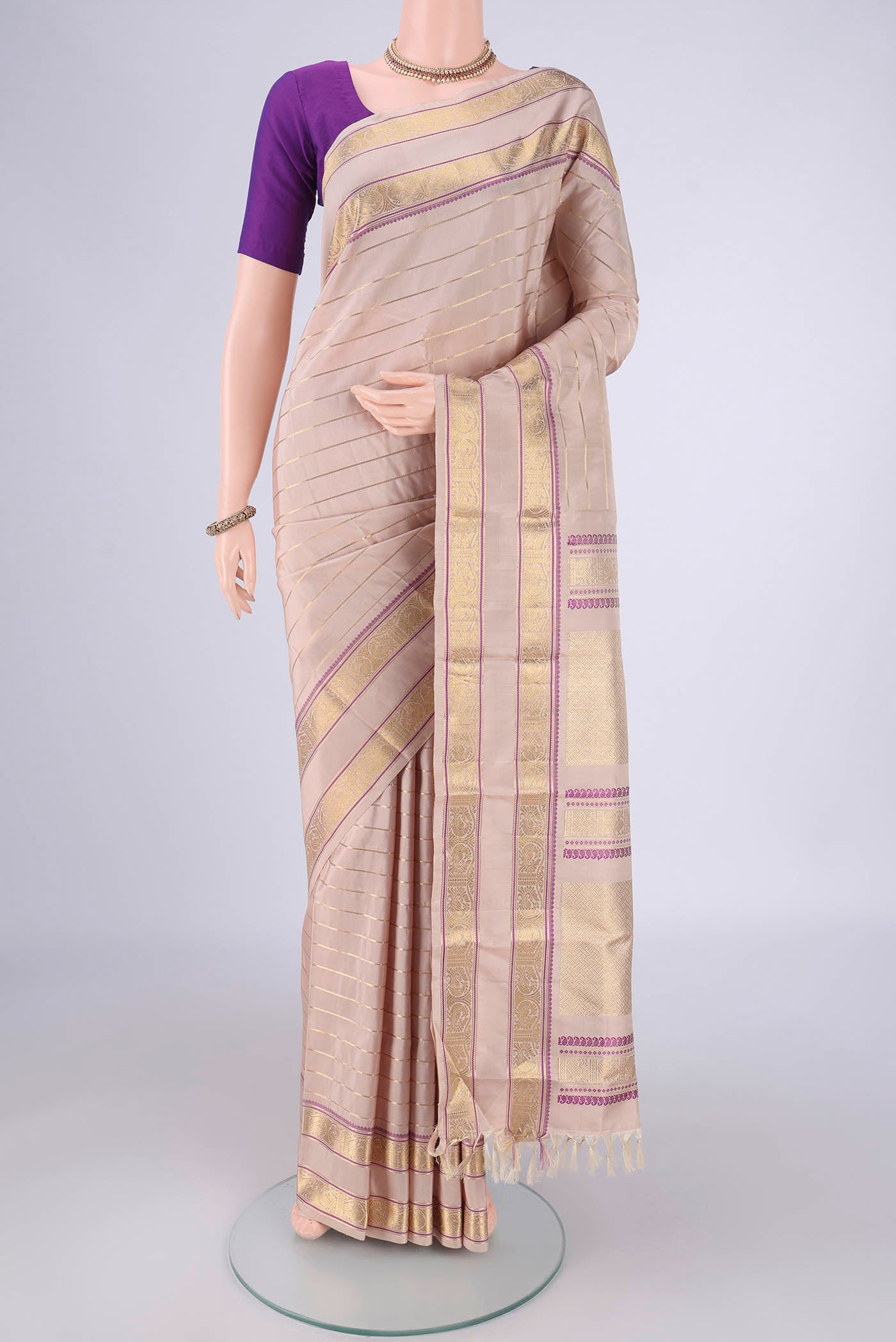 Beige Dual Tone Kanjivaram Silk Saree with Veldhari on the body and Zari And Thread Border.  displayed on a mannequin