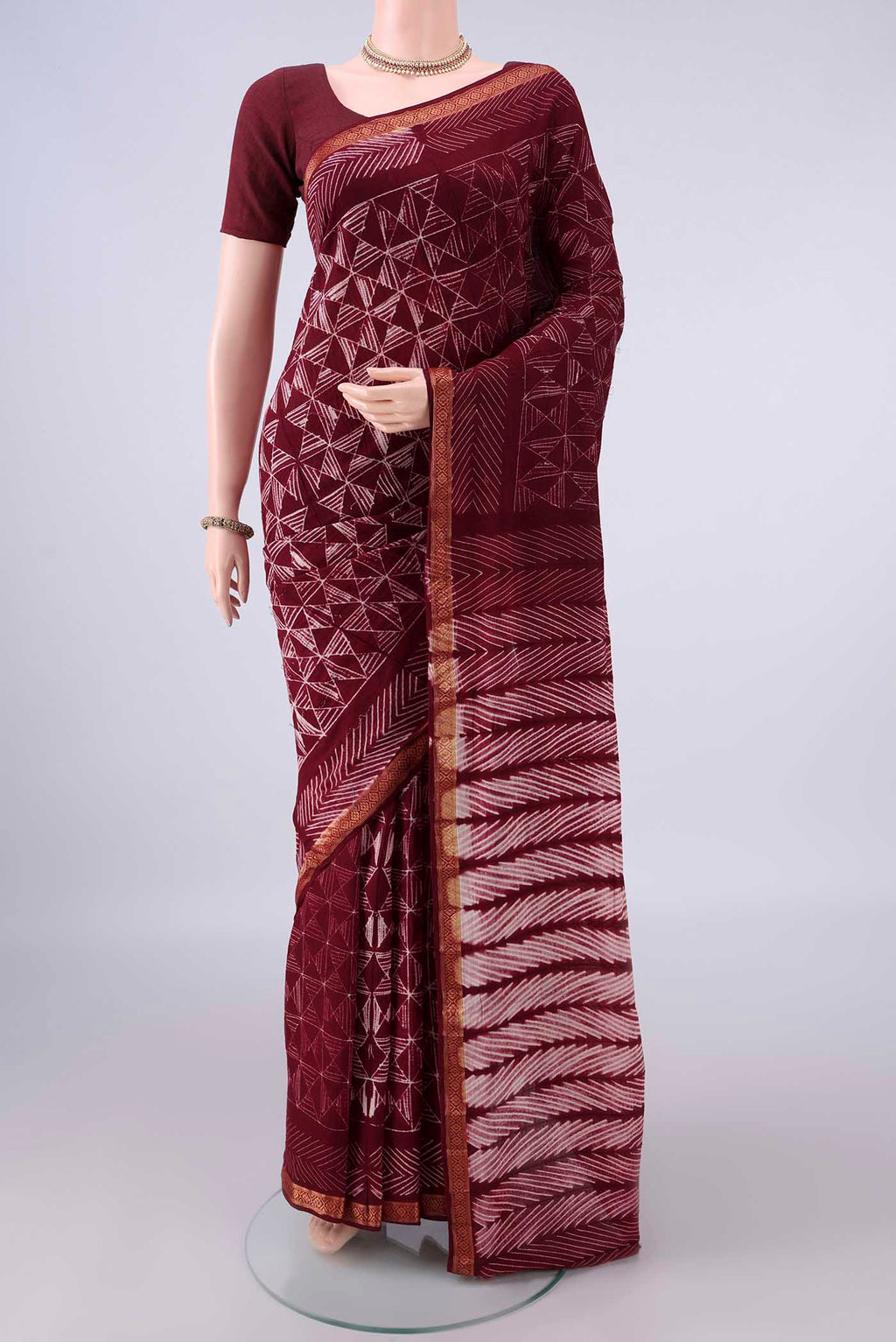 Maroon Cotton Saree with Plain Body and Thread Border.  displayed on a mannequin