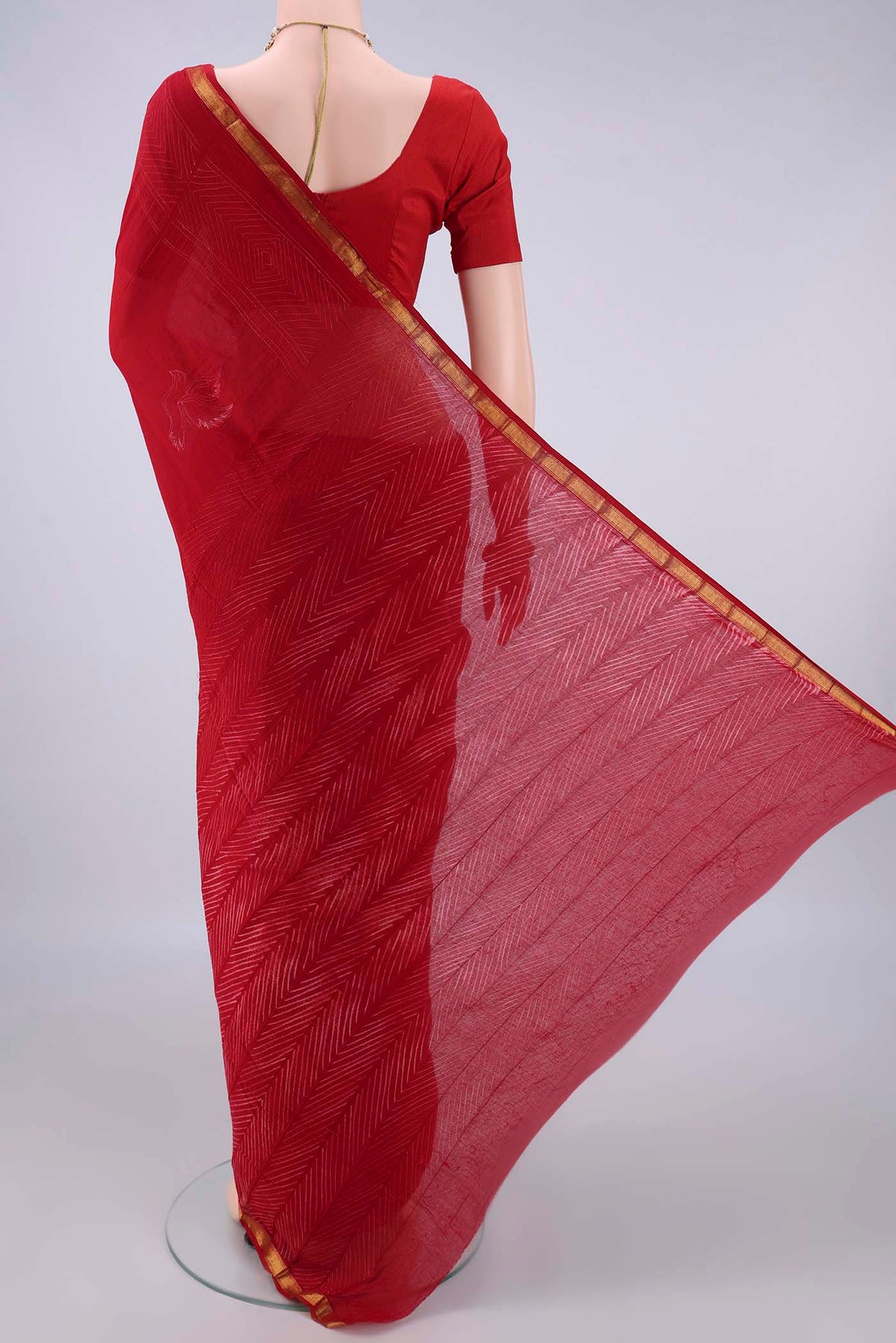 Flat view of Red Cotton Saree with Printed design on the body and Zari Border. 