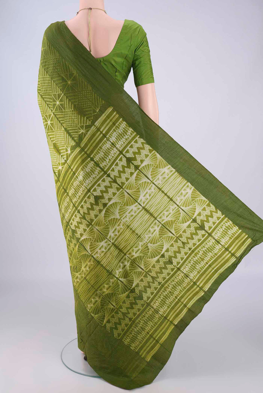 Flat view of Mehandi Green Tussar Silk Saree with Printed design on the body and Plain Border. 