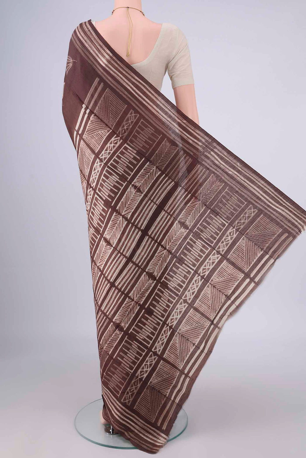 Flat view of Brown Tussar Saree with Printed design on the body and Printed Border. 
