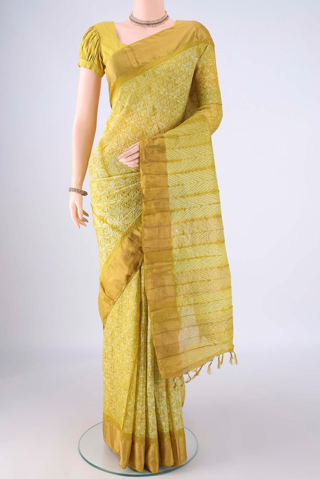 Yellow Tussar Silk Saree with Printed design on the body and Zari Border.  displayed on a mannequin