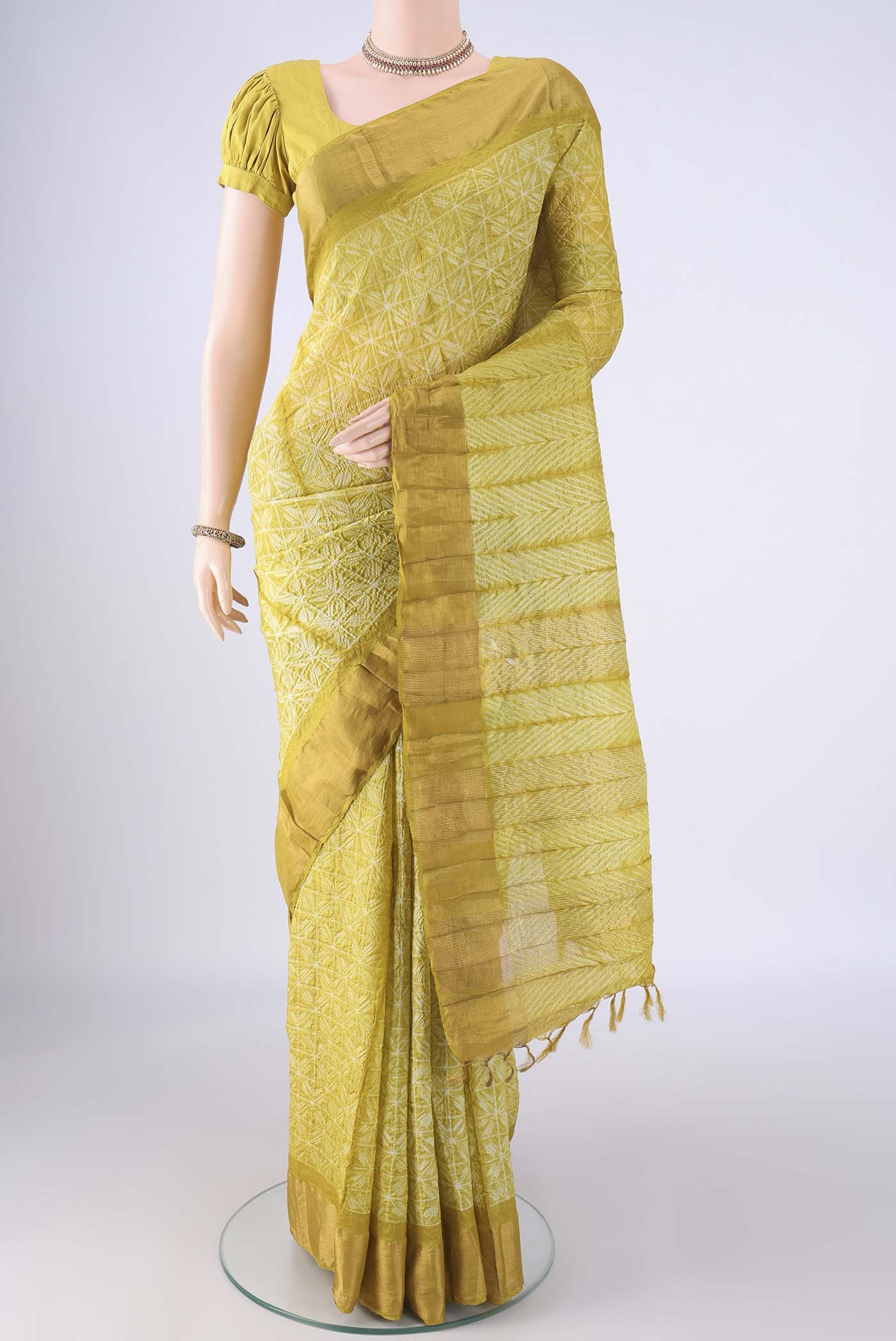 Yellow Tussar Silk Saree with Printed design on the body and Zari Border.  displayed on a mannequin