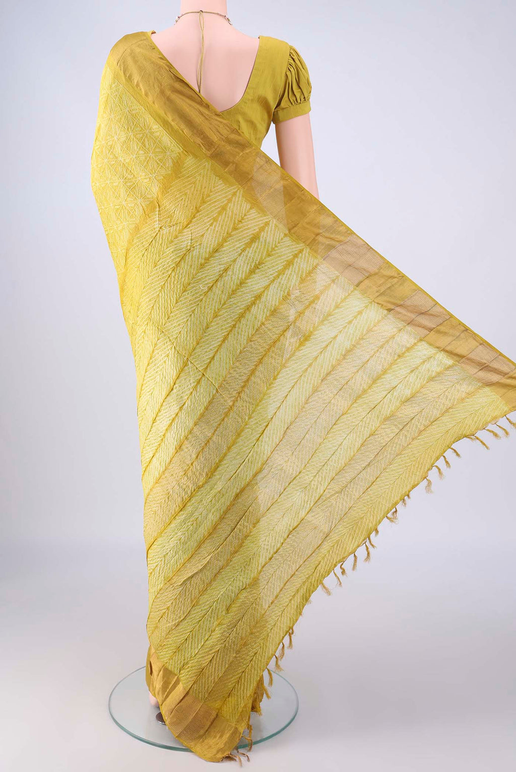 Flat view of Yellow Tussar Silk Saree with Printed design on the body and Zari Border. 