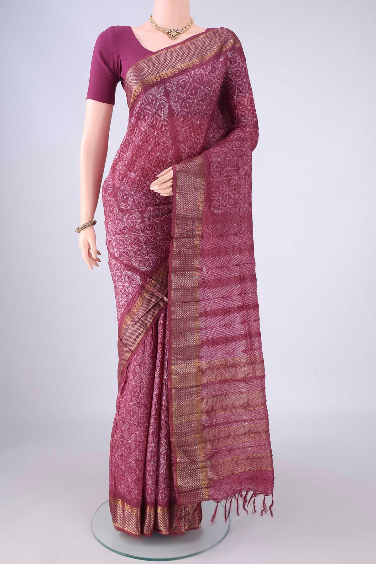 Mauve Tussar Silk Saree with Printed design on the body and Zari Border.  displayed on a mannequin
