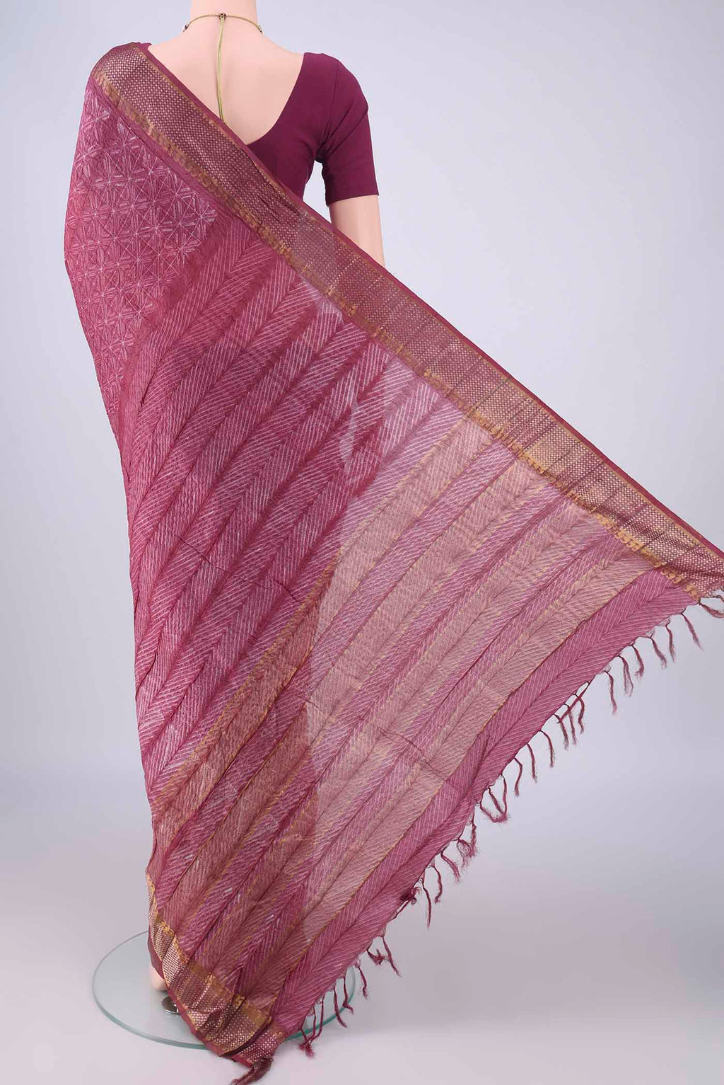 Flat view of Mauve Tussar Silk Saree with Printed design on the body and Zari Border. 