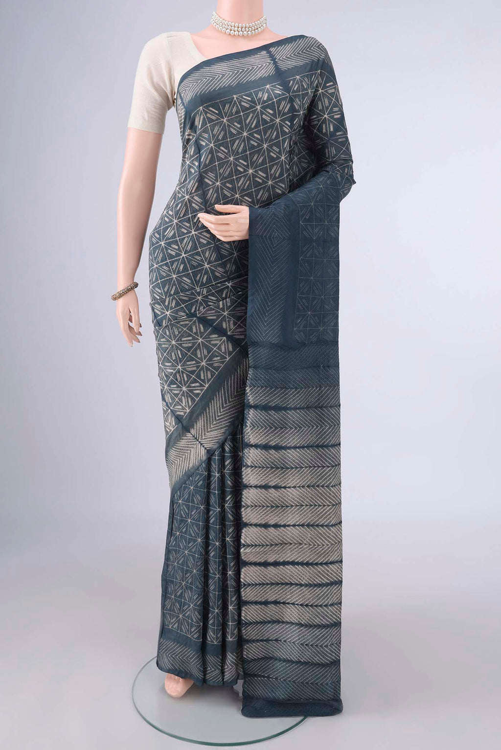 Pure Silk Grey Tussar Saree with Printed design on the body and Without Border.  displayed on a mannequin
