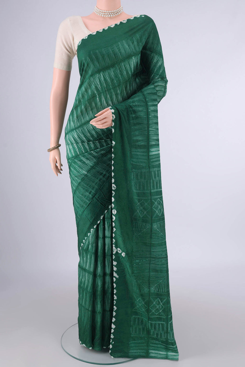Pure Silk Green Printed Saree with Printed design on the body and Printed Border.  displayed on a mannequin