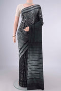 Pure Silk Black Printed Saree with Printed design on the body and Printed Border.  displayed on a mannequin
