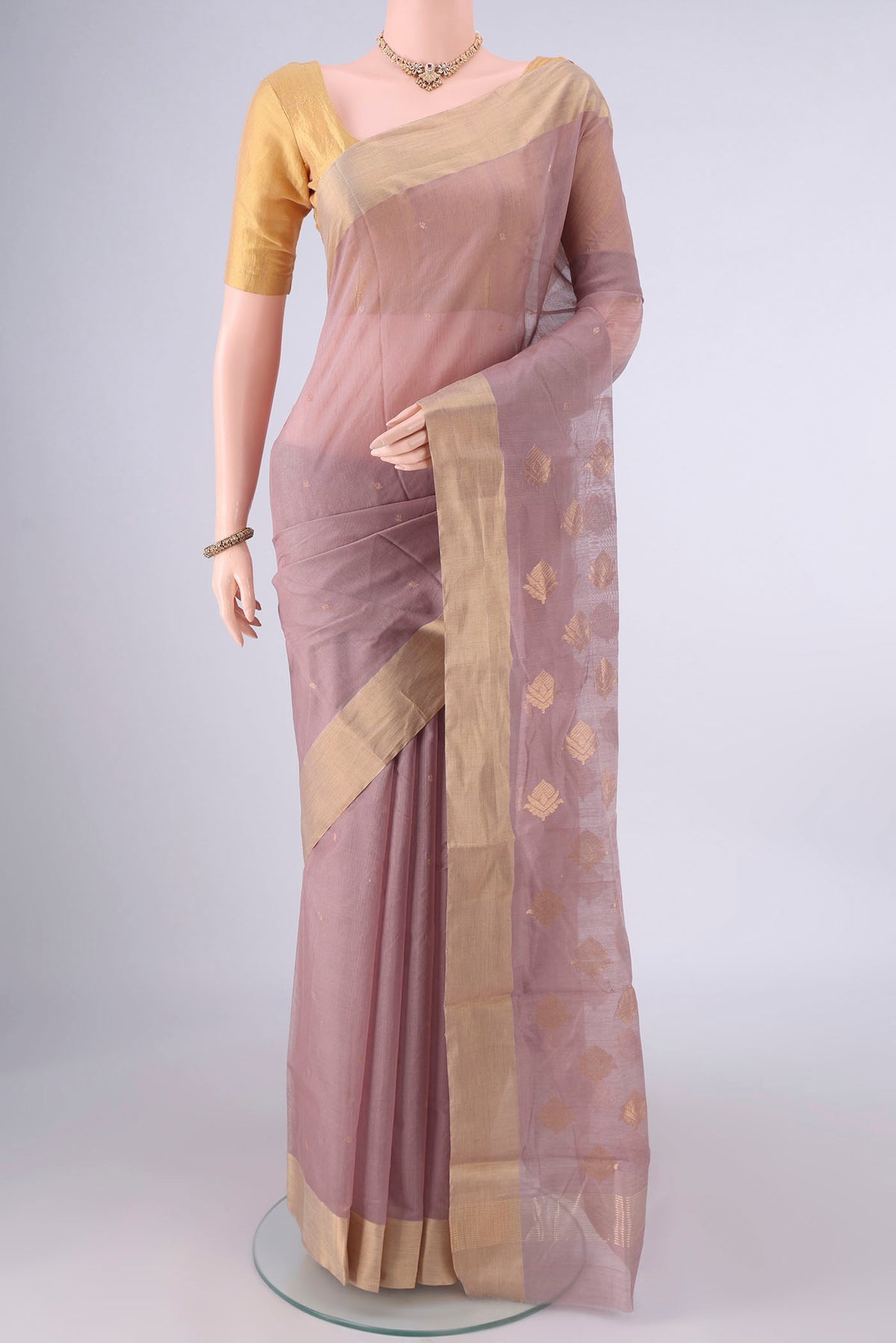 Beige Chanderi Cotton Saree with Zari Butta on the body and Zari Border.  displayed on a mannequin