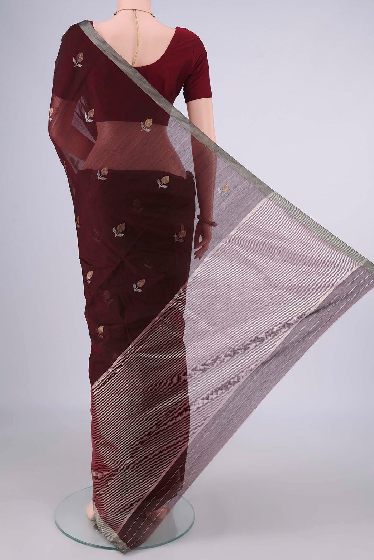 Flat view of Maroon Chanderi Cotton Saree with Zari Butta on the body and Zari Border. 