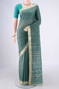 Sage Green Printed Silk Saree with Printed design on the body and Zari Border.  displayed on a mannequin