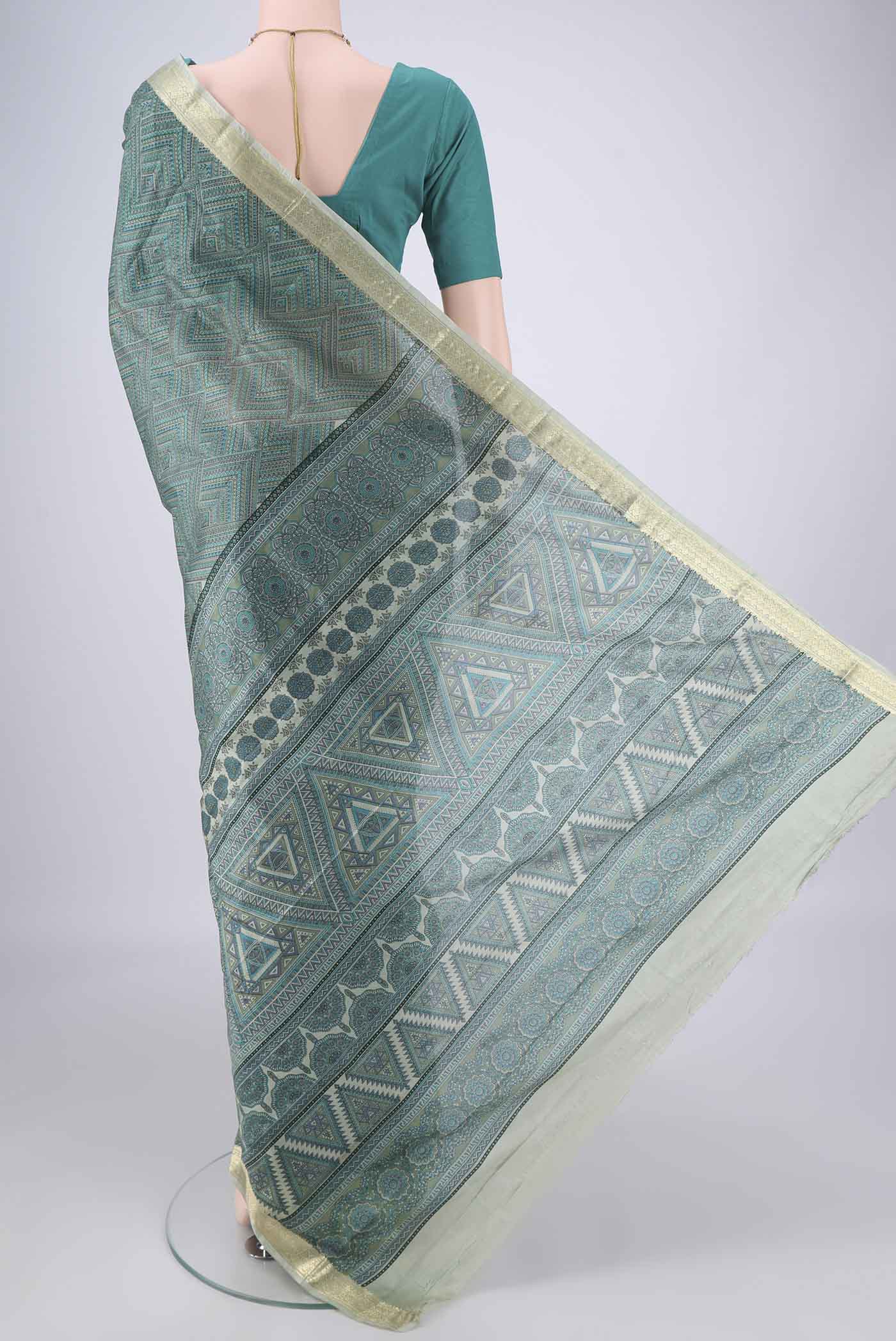 Flat view of Sage Green Printed Silk Saree with Printed design on the body and Zari Border. 