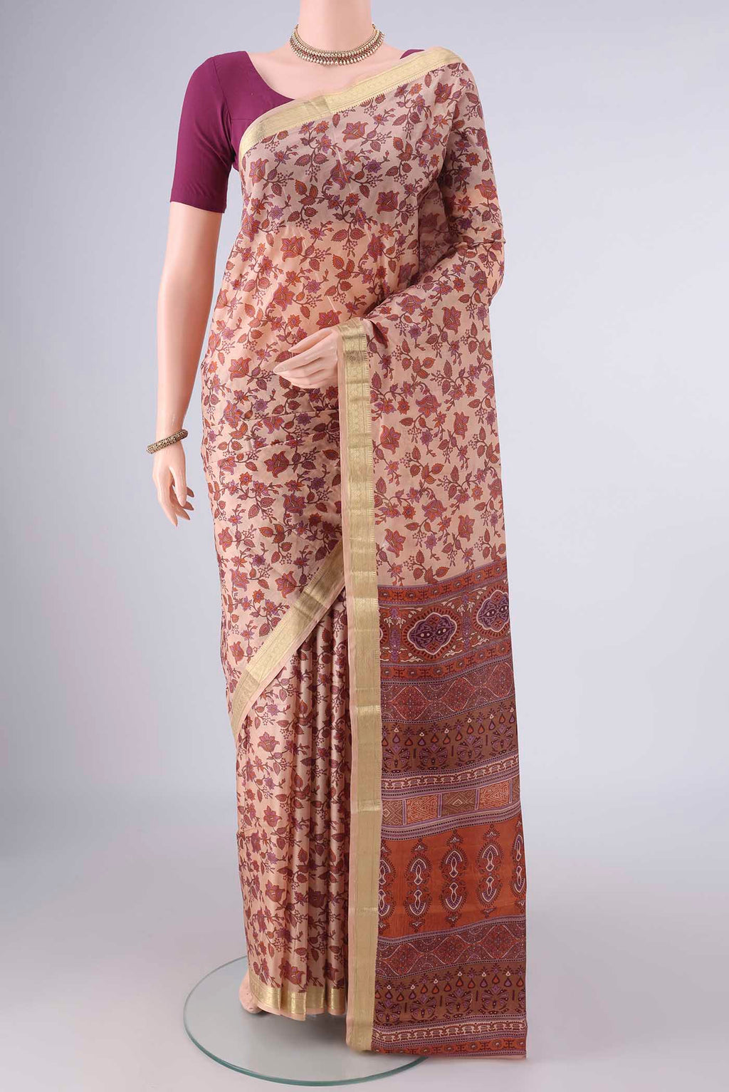 Pure Silk Peach Printed Saree with Printed design on the body and Zari Border.  displayed on a mannequin