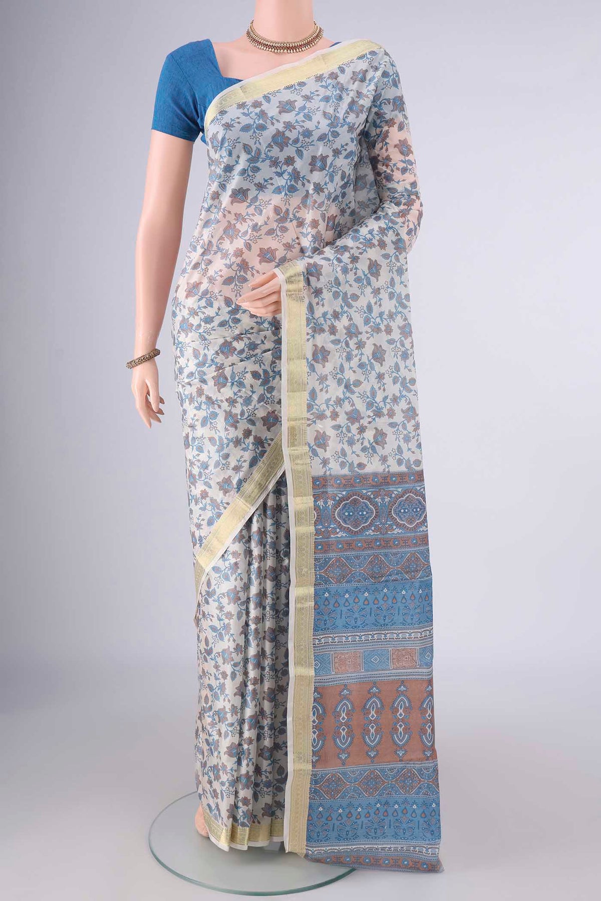 Pure Silk Off White Printed Saree with Printed design on the body and Zari Border.  displayed on a mannequin