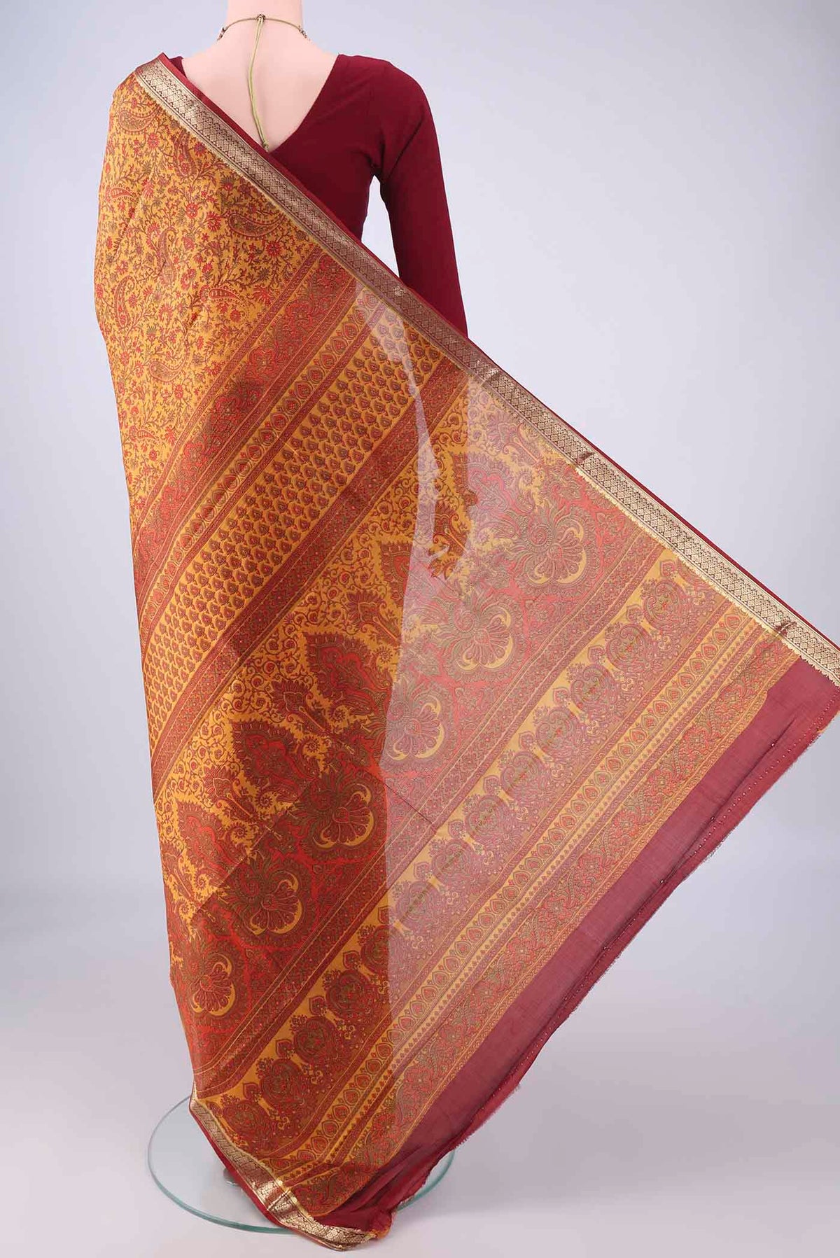 Flat view of Mustard Printed Silk Saree with Printed design on the body and Zari Border. 