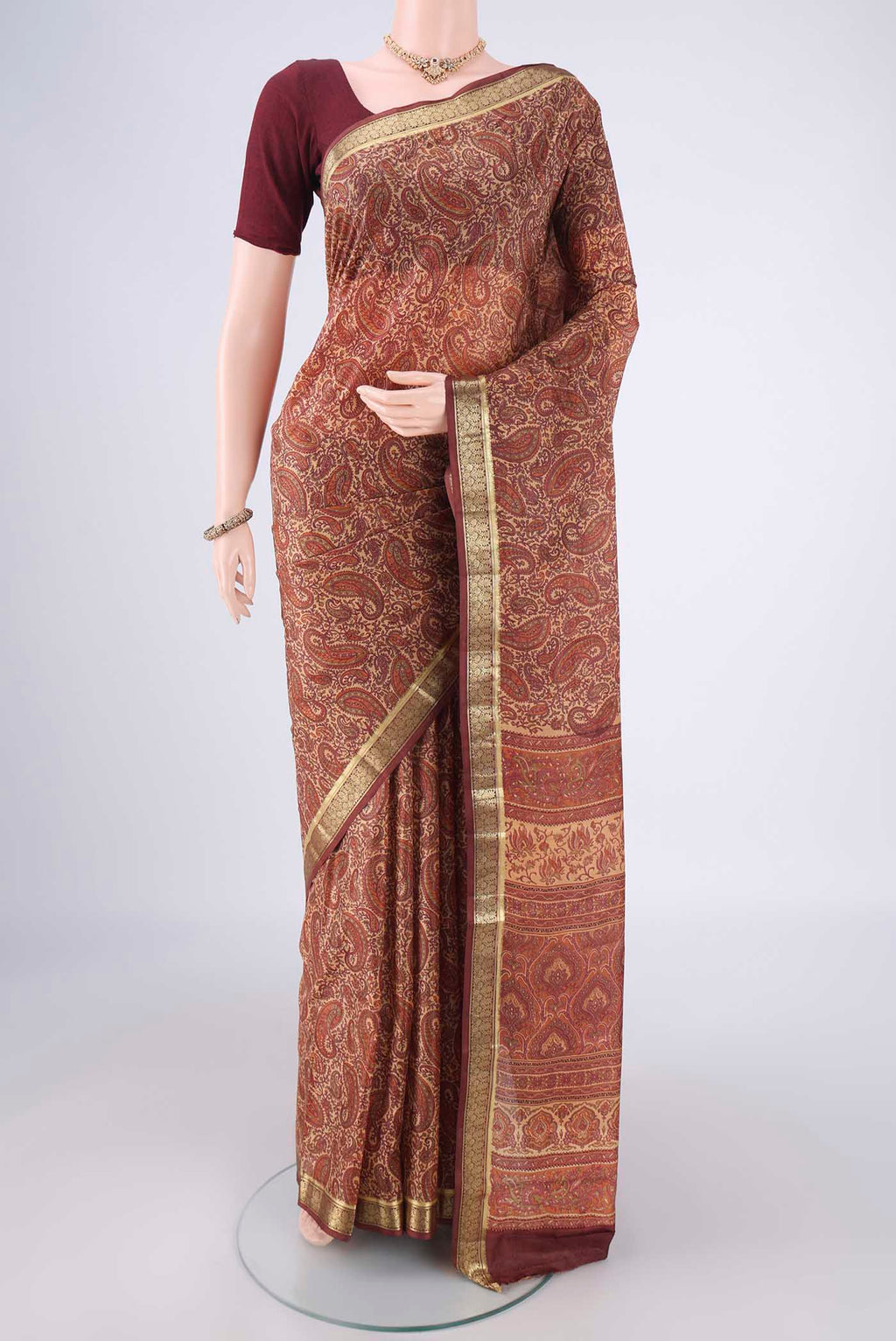 Sandal Printed Silk Saree with Printed design on the body and Zari Border.  displayed on a mannequin