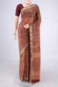 Sandal Printed Silk Saree with Printed design on the body and Zari Border.  displayed on a mannequin