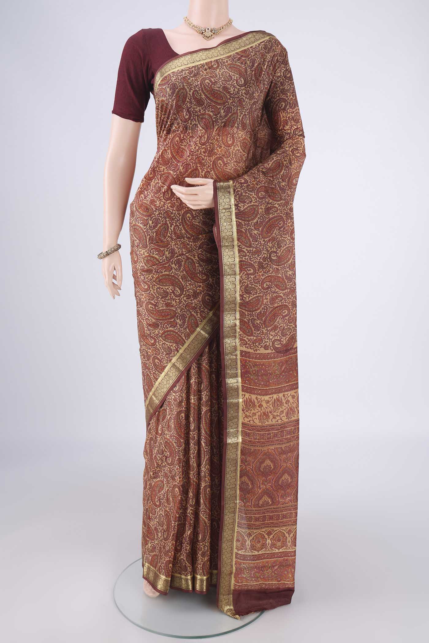 Sandal Printed Silk Saree with Printed design on the body and Zari Border.  displayed on a mannequin