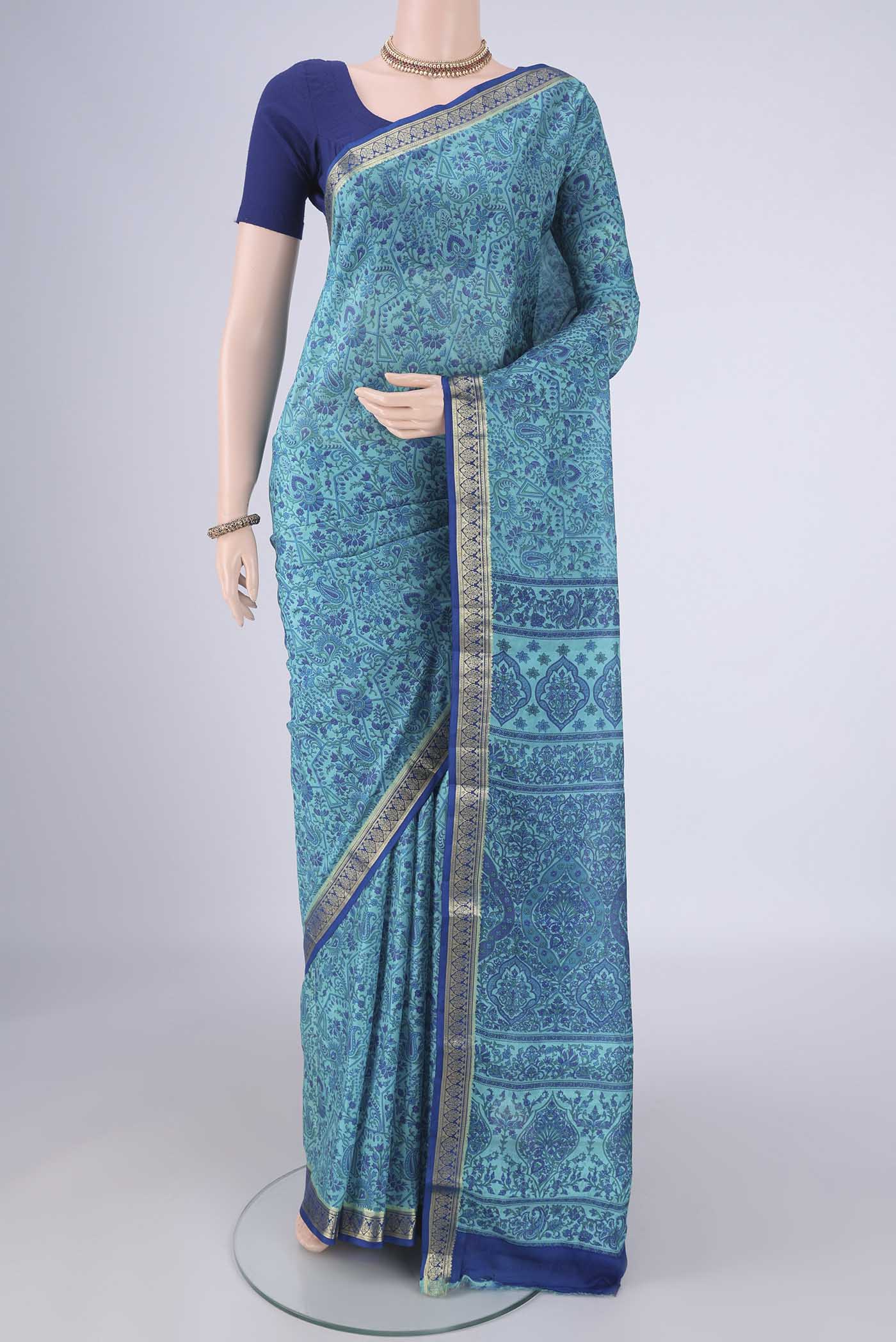 Blue Printed Silk Saree with Printed design on the body and Zari Border.  displayed on a mannequin
