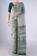 Off White Printed Silk Saree with Printed design on the body and Zari Border.  displayed on a mannequin