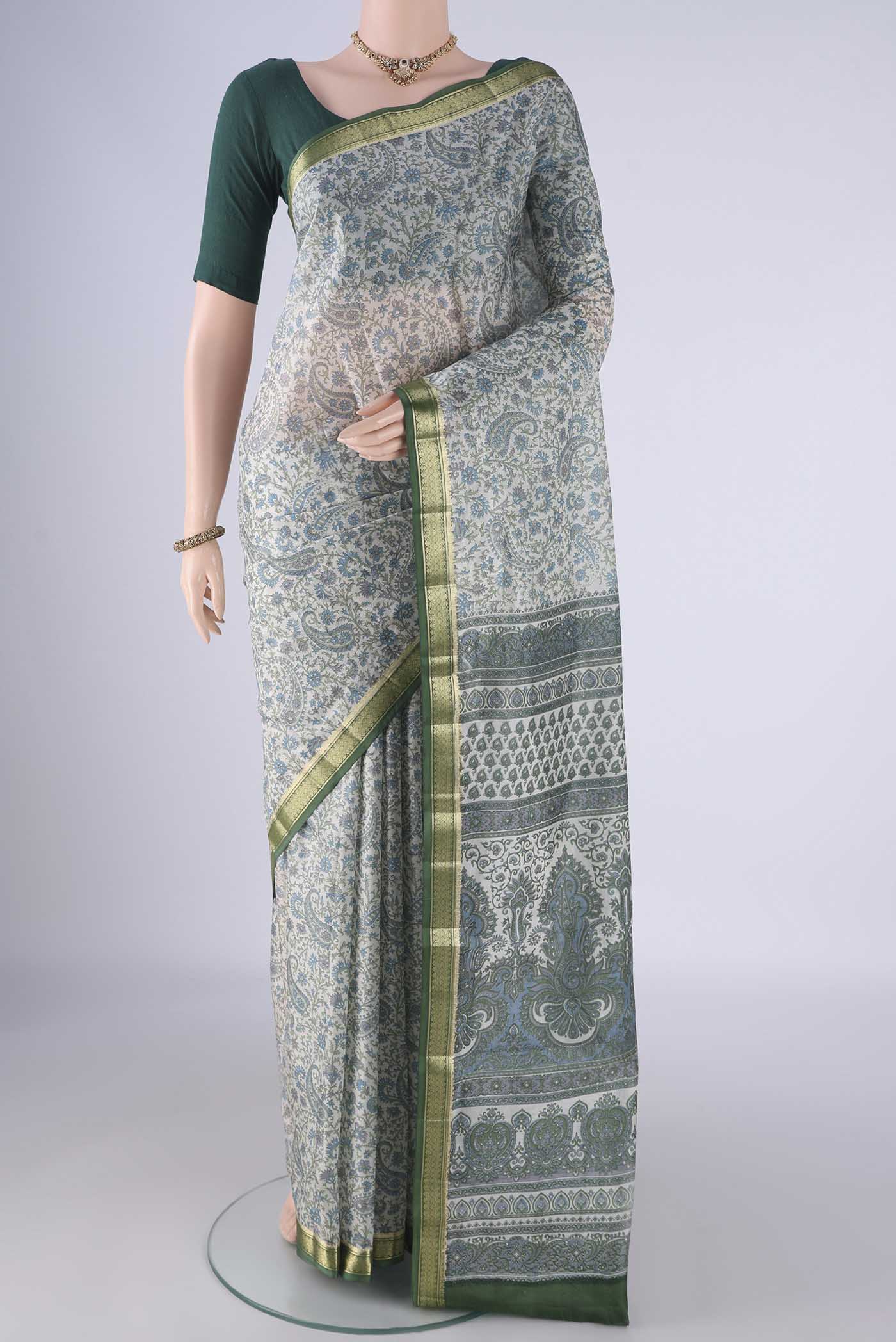 Off White Printed Silk Saree with Printed design on the body and Zari Border.  displayed on a mannequin