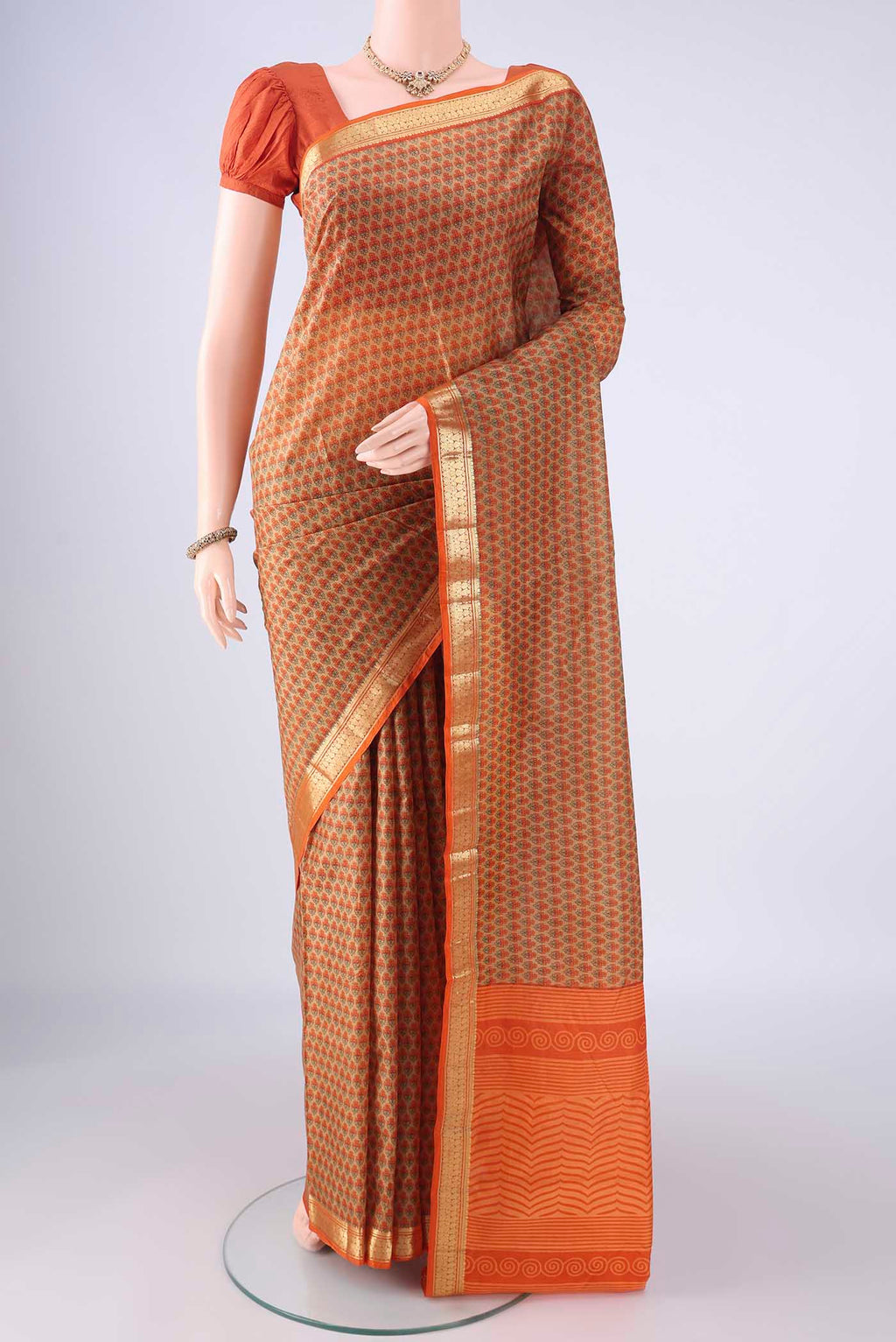 Dark Beige Printed Silk Saree with Printed design on the body and Zari Border.  displayed on a mannequin