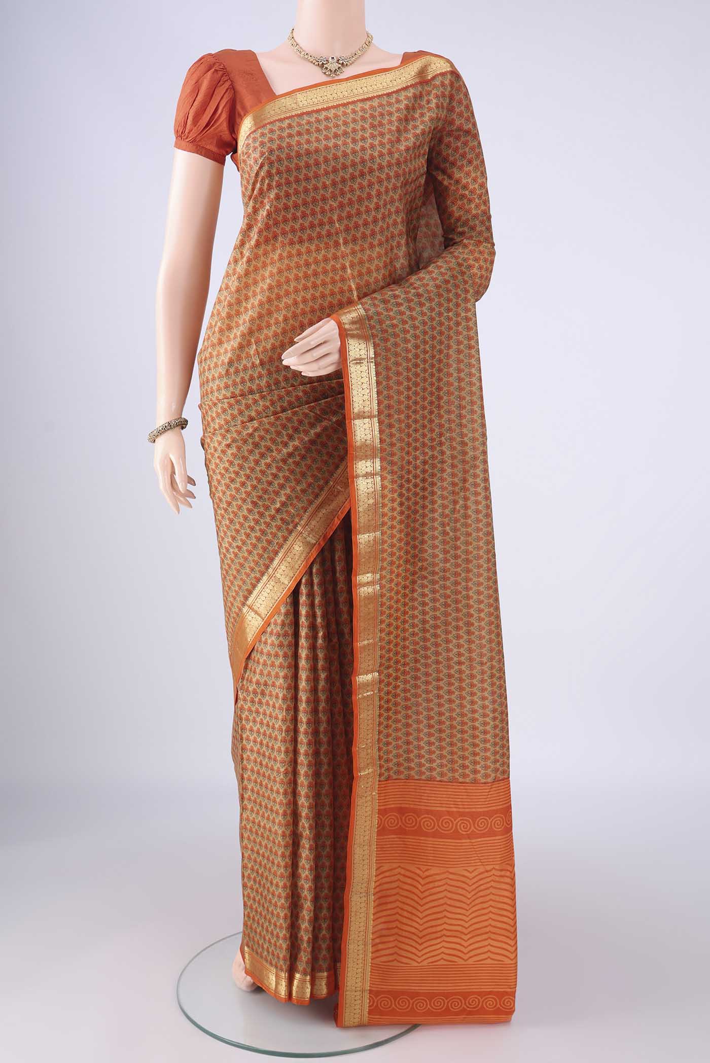 Dark Beige Printed Silk Saree with Printed design on the body and Zari Border.  displayed on a mannequin