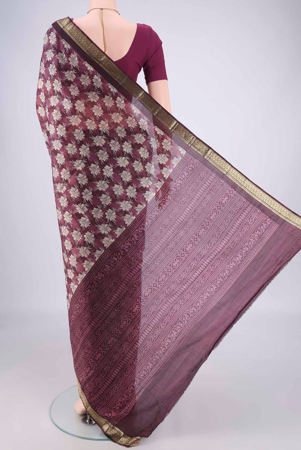 Flat view of Burgundy Printed Silk Saree with Printed design on the body and Zari Border. 