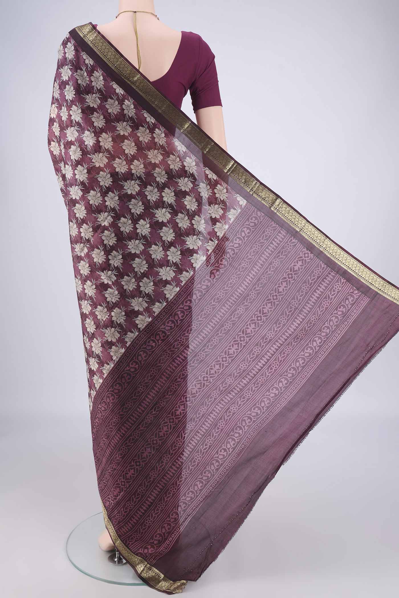 Flat view of Burgundy Printed Silk Saree with Printed design on the body and Zari Border. 