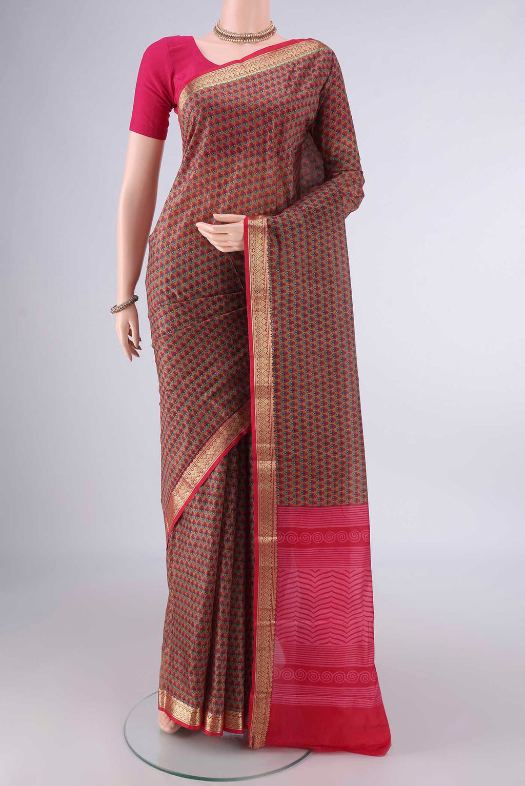 Pure Silk Brown Printed Saree with Printed design on the body and Zari Border.  displayed on a mannequin