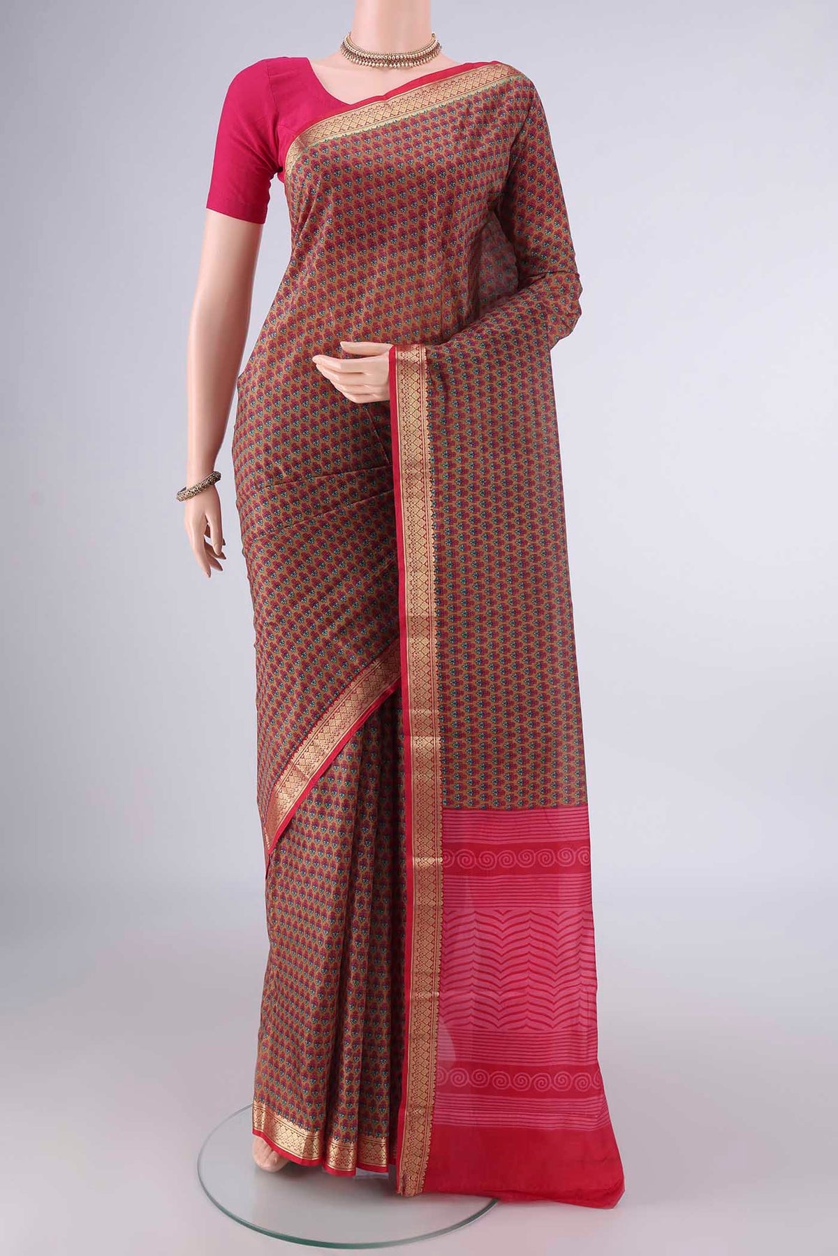 Pure Silk Brown Printed Saree with Printed design on the body and Zari Border.  displayed on a mannequin