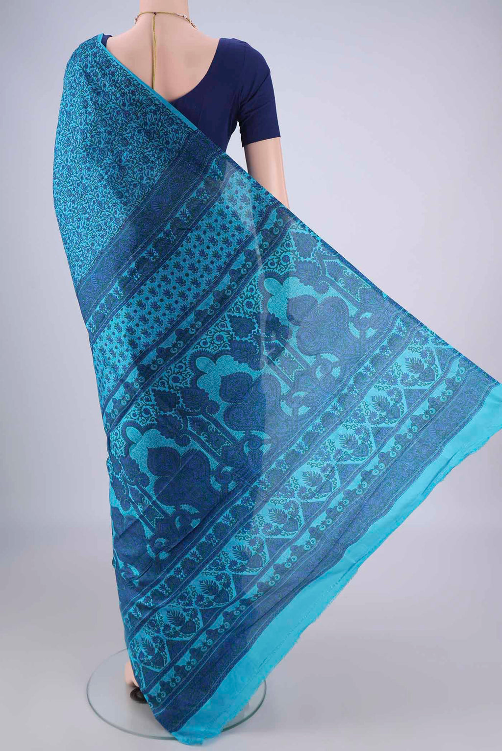 Flat view of Blue Printed Silk Saree with Printed design on the body and Plain Border. 