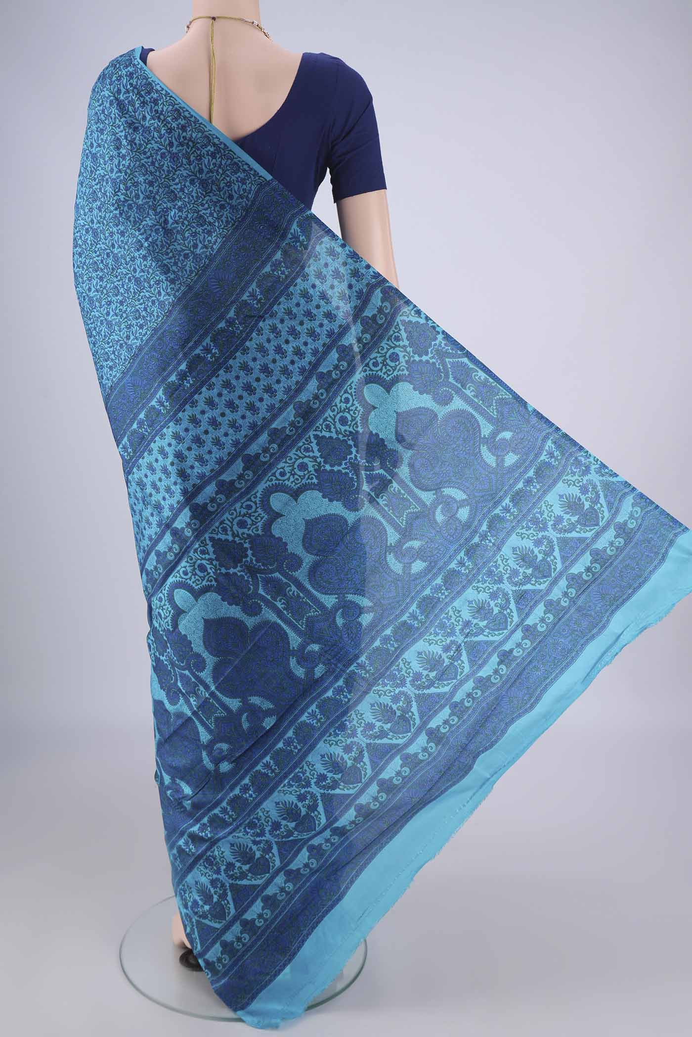 Flat view of Blue Printed Silk Saree with Printed design on the body and Plain Border. 