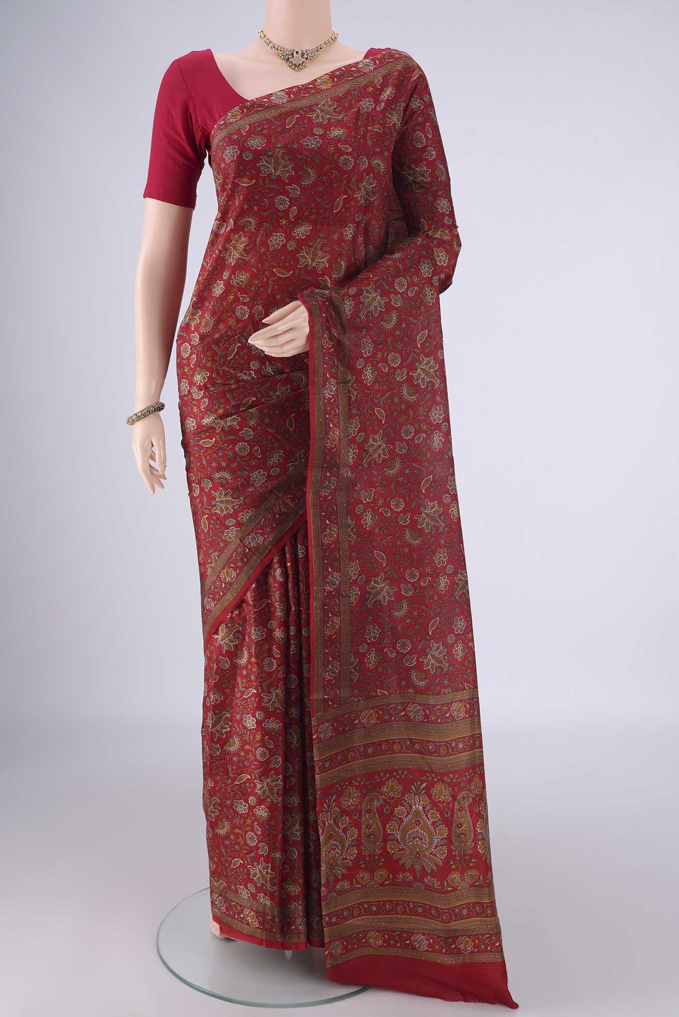 Maroon Printed Silk Saree with Printed design on the body and Zari Border.  displayed on a mannequin