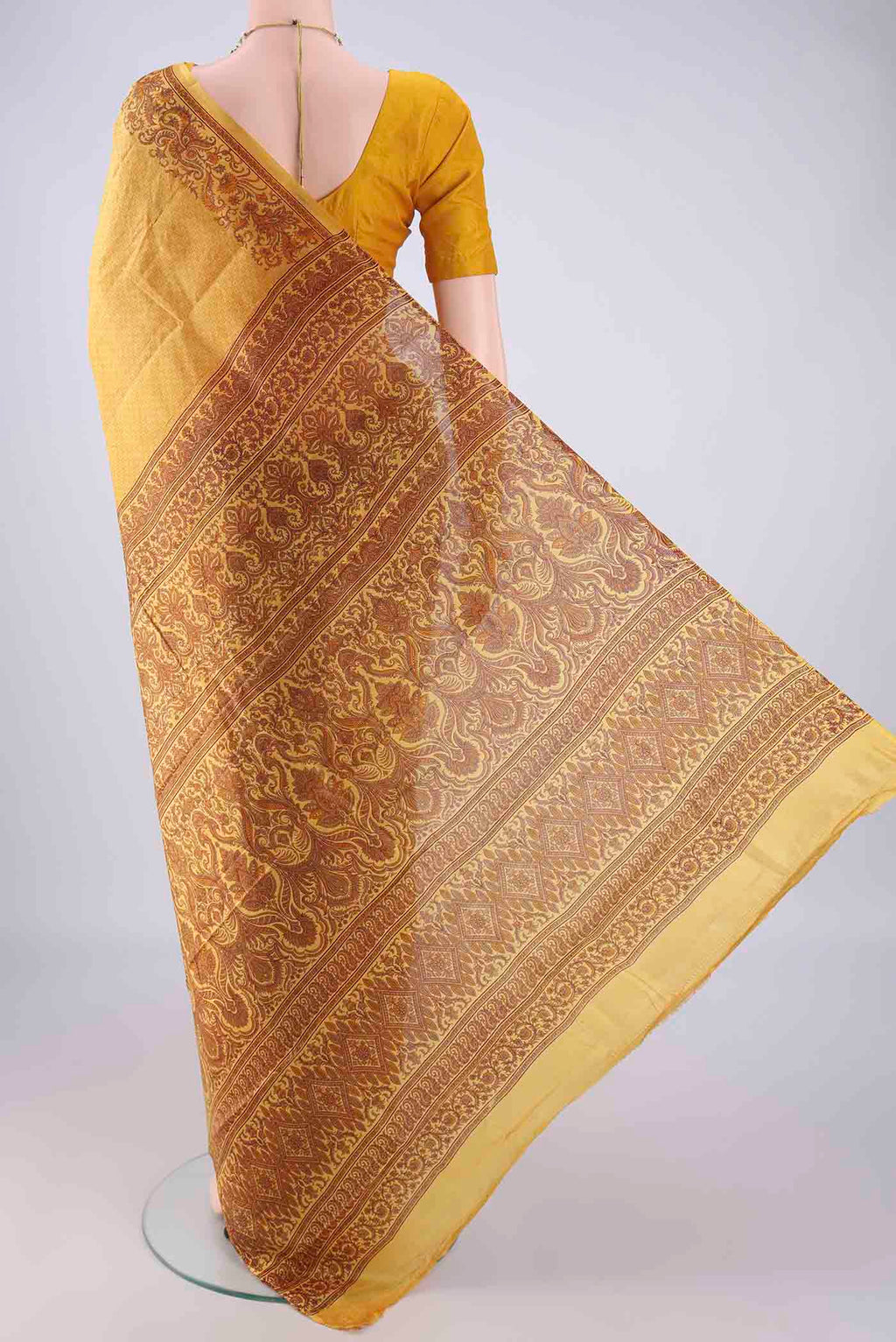 Flat view of Mustard Printed Silk Saree with Printed design on the body and Printed Border. 
