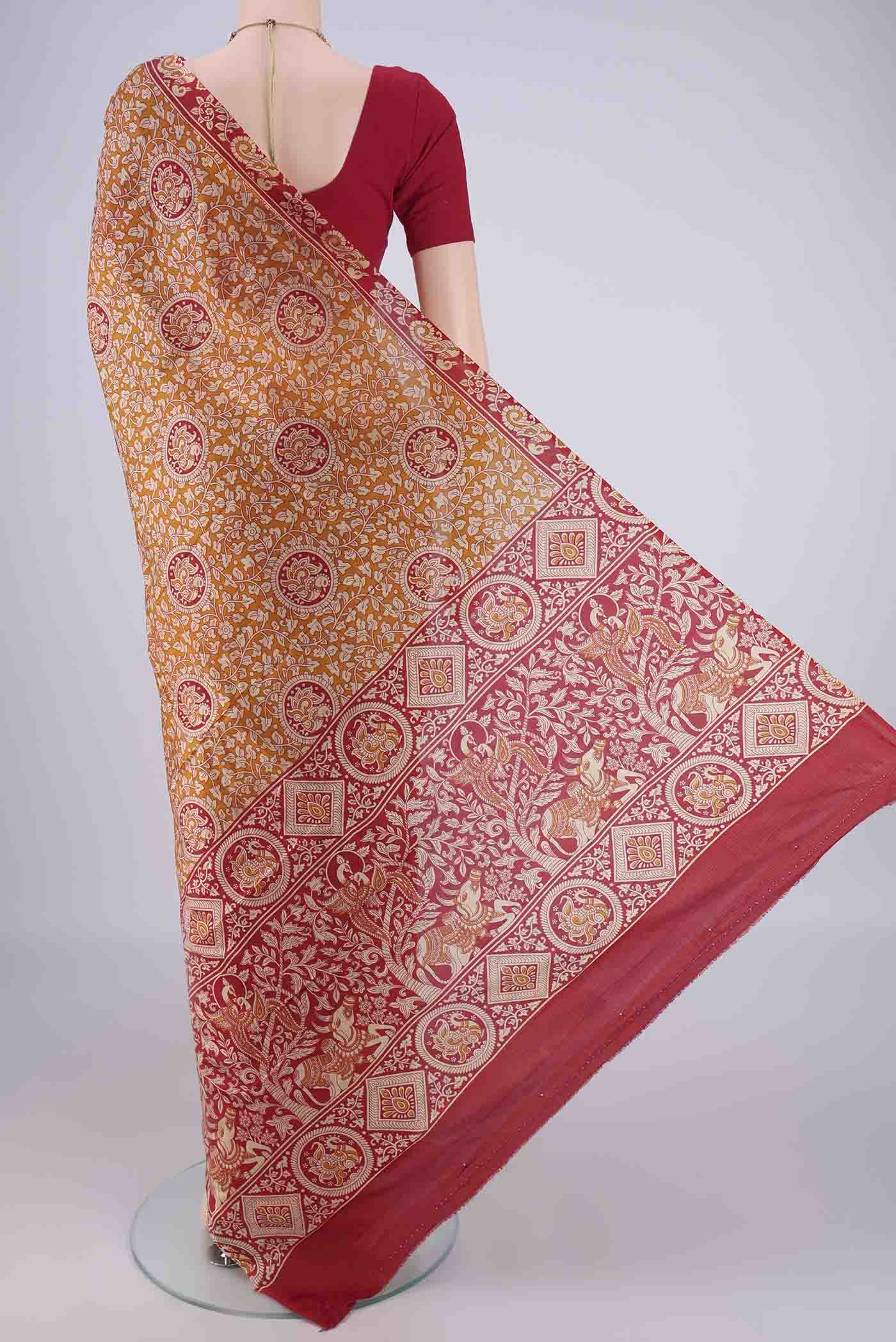 Flat view of Rust Printed Silk Saree with Printed design on the body and Zari Border. 
