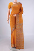 Mustard Printed Silk Saree with Plain Body and Printed Border.  displayed on a mannequin